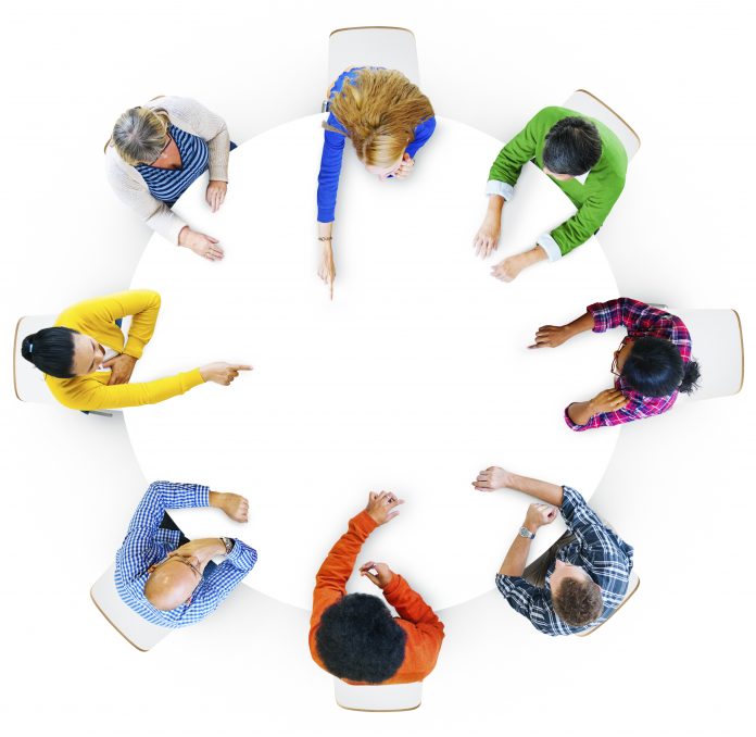 Aerial view of hands pointing in design space area