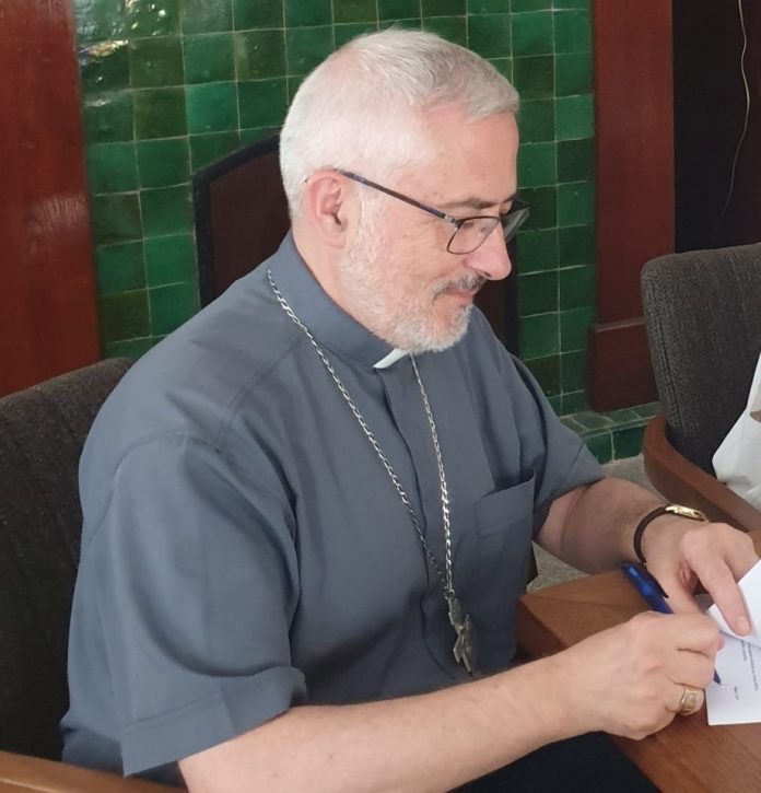 Fr Emilio detalle firmando